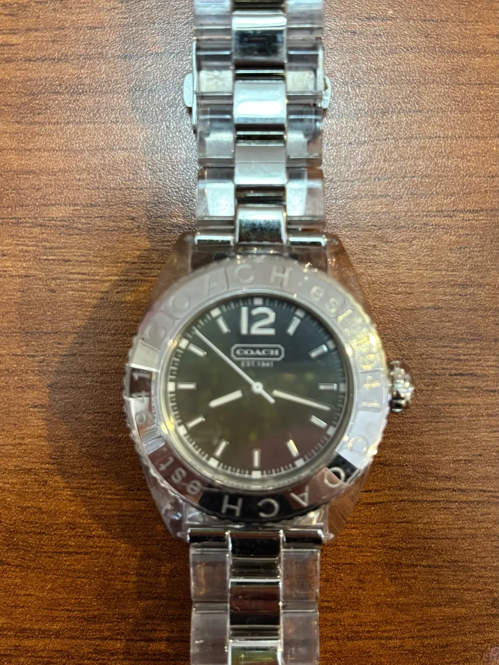 Coach women’s Silver Tone Watch with Black Dial and clear acrylic band